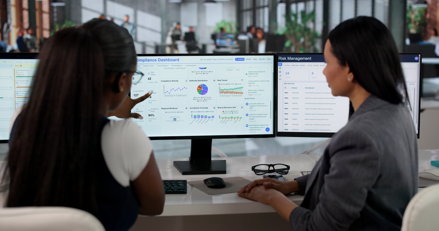 2 female security professionals reviewing credential data on a computer screen to investigate after a security breach